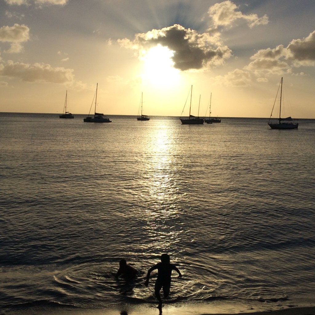 Boys in water at sunset
